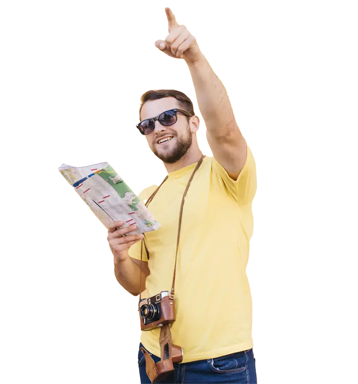 a traveler in a yellow shirt holding a map and pointing upwards, with a camera over the shoulder.