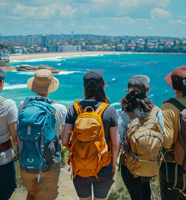 Group of tourists with backpacks overlooking a coastal cityscape