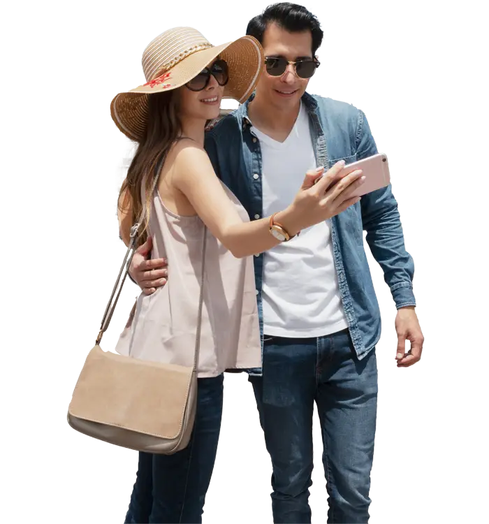 A couple taking a selfie, woman in a sun hat and man in a denim jacket