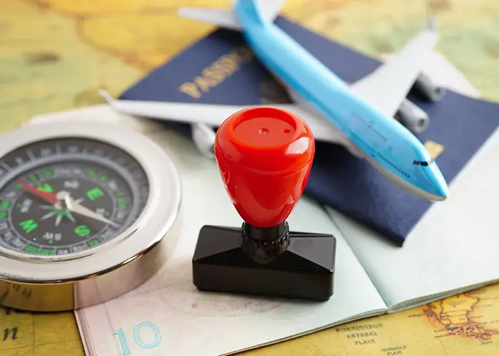 passsport, hand held stamp and compass